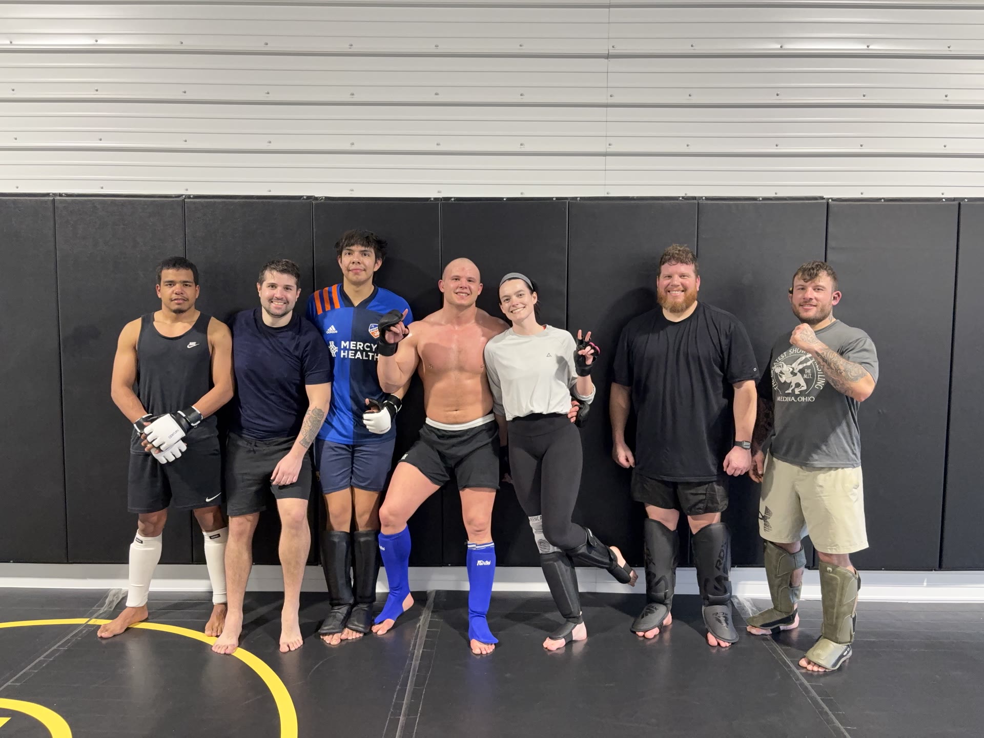 Golden Oak Combat Club members and coaches gathered together on the mats after training