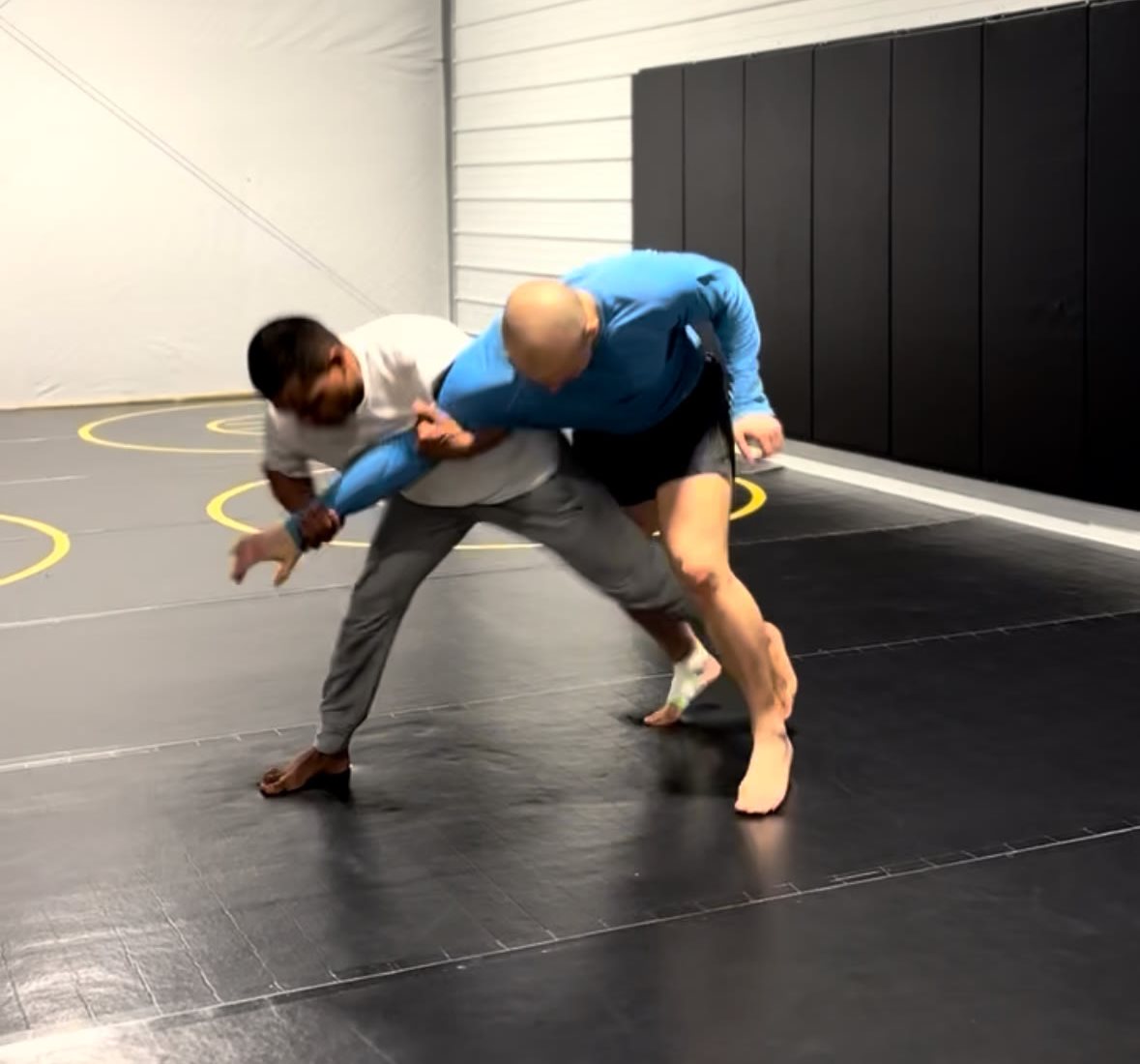 Two wrestlers fighting for position from a Russian tie during wrestling practice